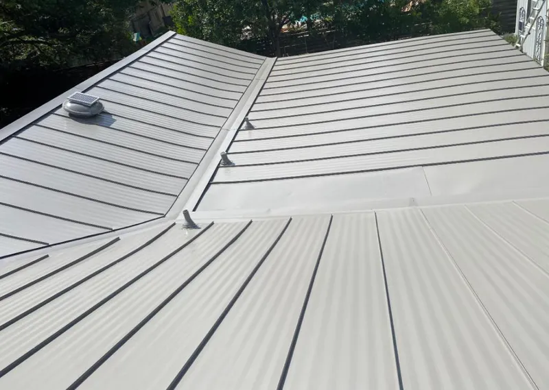 Solar attic fan installed on a metal roof for Roof Ventilation in Polk City