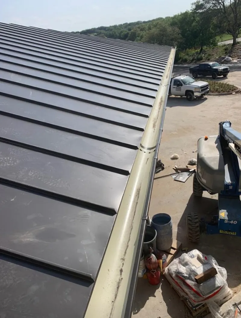Standing seam panel and gutter detail on a metal roofing jobsite in Polk City